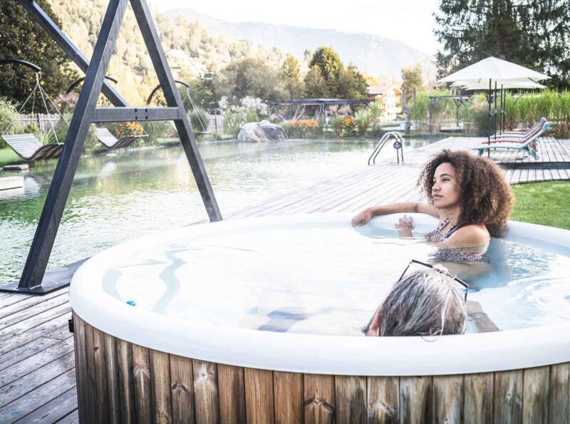 Lady sitting in the hot tub at the natural swimming pool