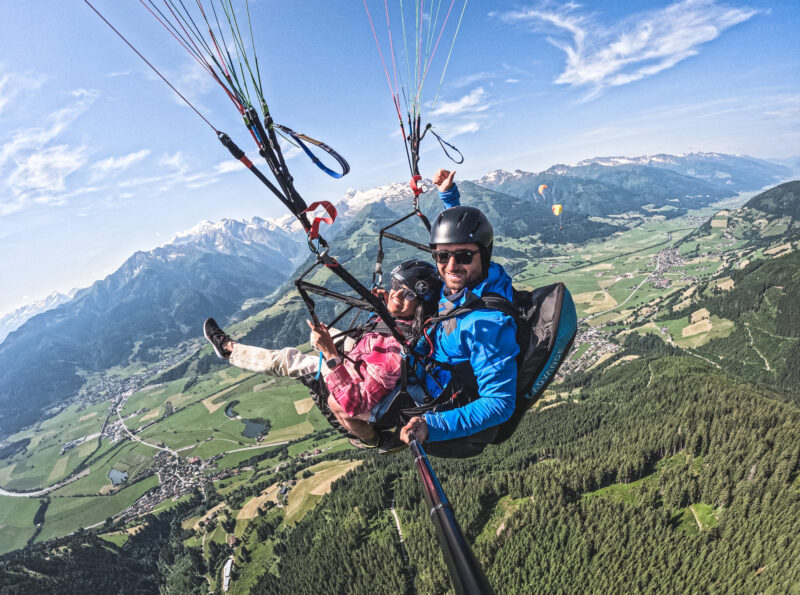 Flight with a tandem paraglider in summer